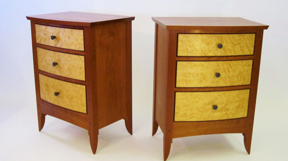 Cherry and figured maple nightstands with curved birdseye maple drawers accented with a fine walnut bead, all set in solid cherry casework