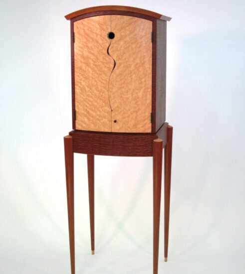 Custom standing cabinet in pommele sapele and birdseye maple veneers, solid mahogany and abalone