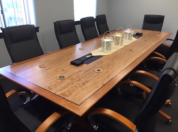 Custom conference table with eucalyptus veneer, ebonized inlay border, solid cherry, and cherry veneer