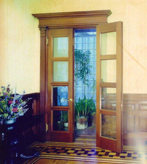 Tall Atrium Doors in white oak with insulated glass and adjoining wall paneling
