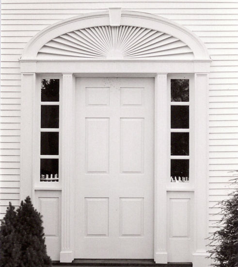 Traditional entry with sidelights and elliptical fan in painted mahogany in Vermont